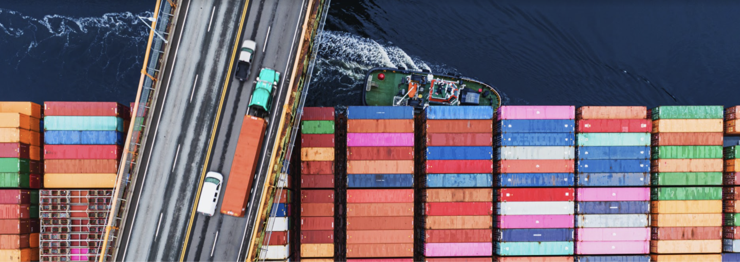 Image - shipping freighter passing underneath a bridge