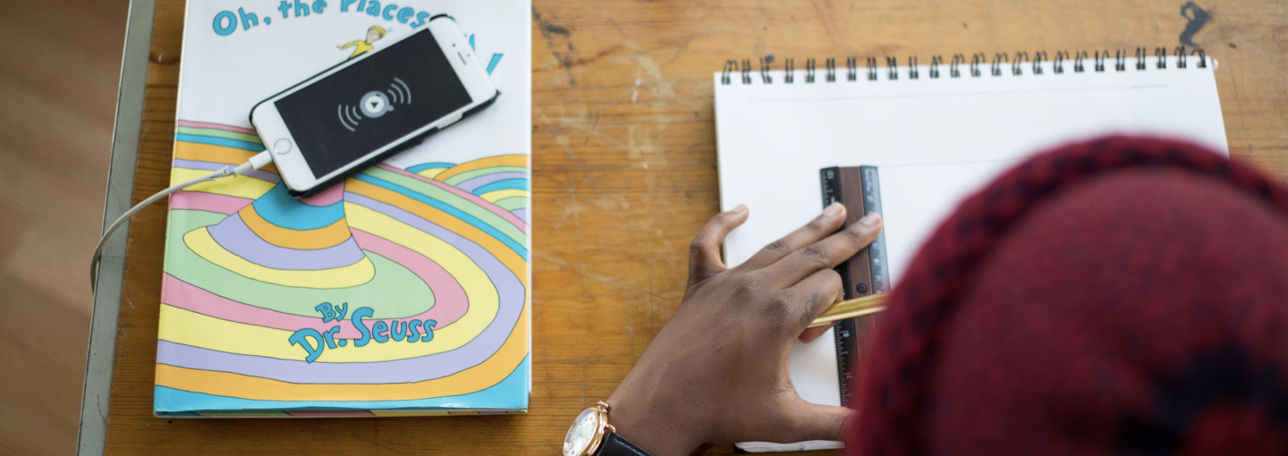 Image - student working with pencil, ruler and paper next to book and smarphone